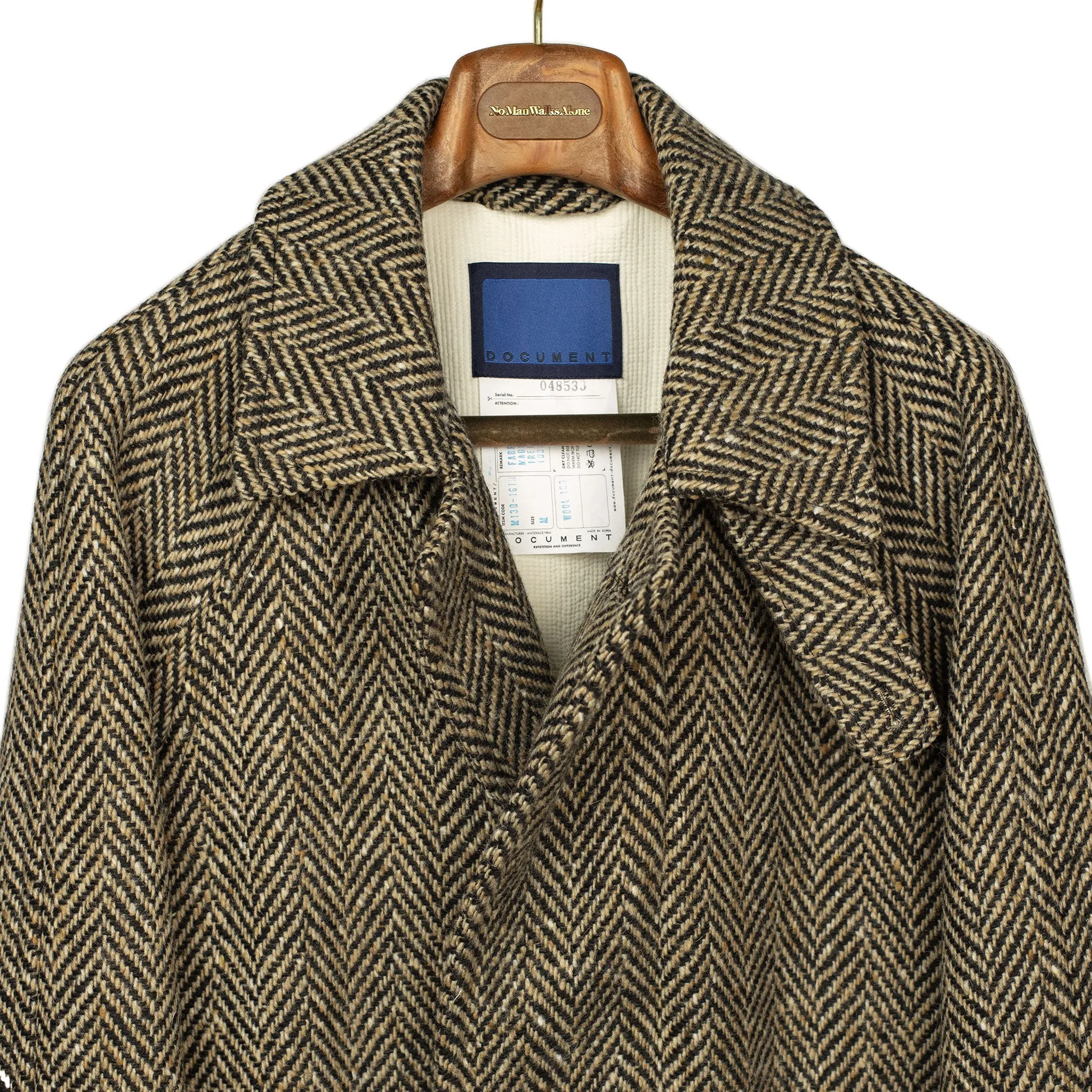 Belted balmacaan in oatmeal and black herringbone wool donegal tweed